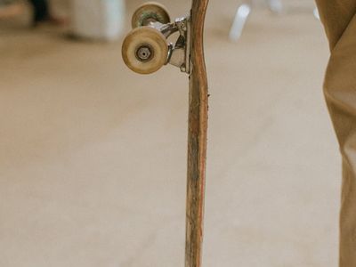 Close-up of a person's hands gripping the floor for balance.